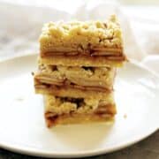Shortbread bars on a plate stacked up.
