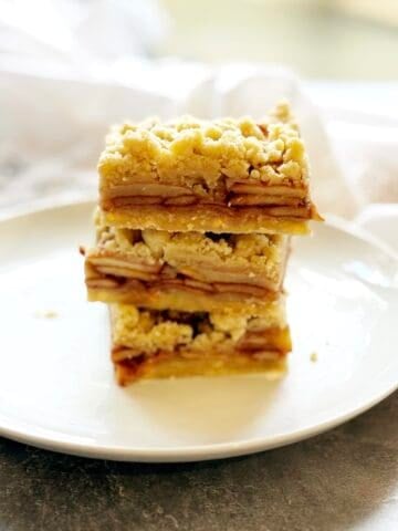 Shortbread bars on a plate stacked up.