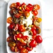 Tomato and ricotta salad on a plate.