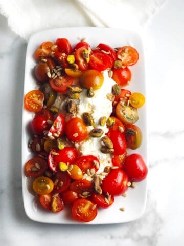 Tomato and ricotta salad on a plate.