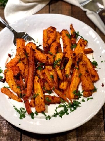 Harissa roasted carrots on a plate.