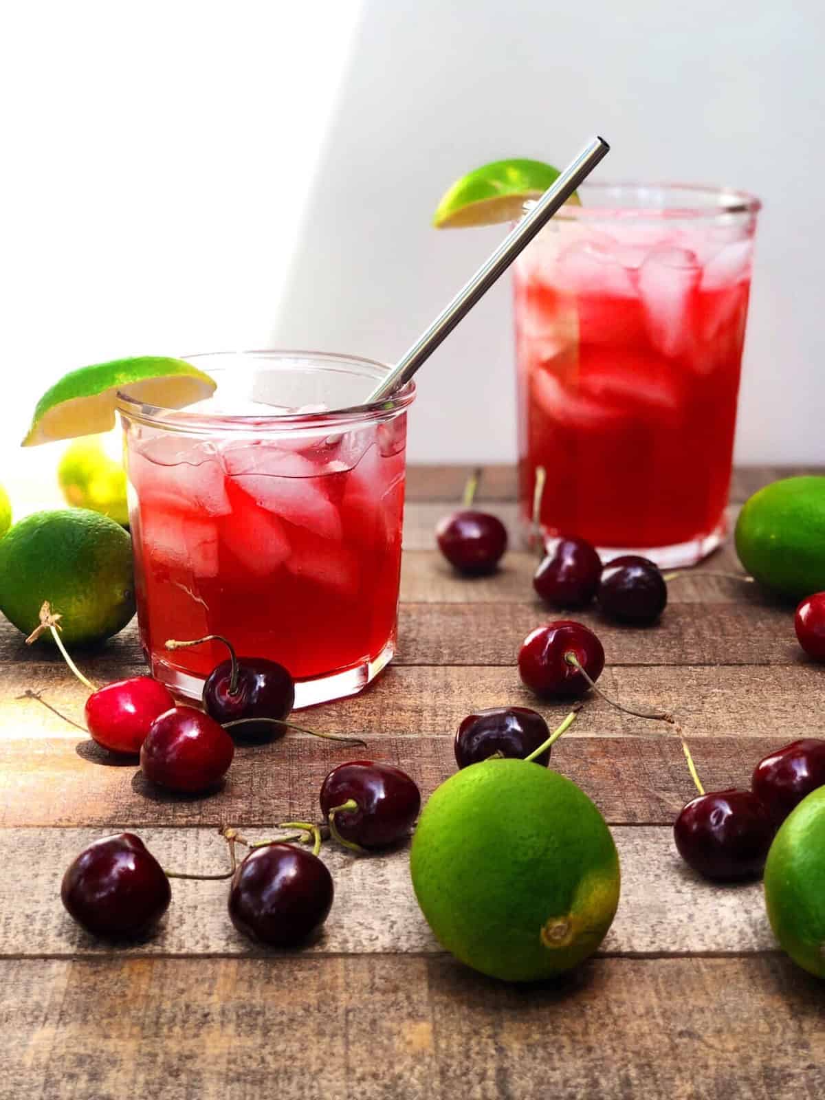 Two glasses of cherry limeade on the counter.